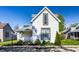 Charming two-story home featuring white siding, well-manicured lawn, and an inviting front garden at 139 N East St, Pendleton, IN 46064