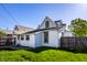 Charming home exterior with green lawn, wooden fence, and white siding at 139 N East St, Pendleton, IN 46064