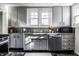 Charming kitchen featuring grey cabinetry, granite countertops, stainless steel appliances and a window at 139 N East St, Pendleton, IN 46064