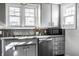 Bright kitchen with stainless steel appliances, gray cabinets, and natural light from multiple windows at 139 N East St, Pendleton, IN 46064