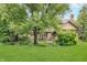 Lush backyard featuring mature trees, and landscaping, creating a private outdoor oasis at 1421 Stoney Creek Cir, Carmel, IN 46032