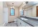 Well-lit bathroom with granite vanity, modern fixtures, and soaking tub with tile surround at 1421 Stoney Creek Cir, Carmel, IN 46032