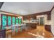 Open dining area with hardwood floors, a white table, wooden trim, and a bay window overlooking the outdoors at 1421 Stoney Creek Cir, Carmel, IN 46032