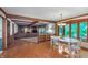 Dining area featuring wood floors, a white table, a view of the living room, and an exterior view at 1421 Stoney Creek Cir, Carmel, IN 46032
