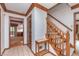 Entryway featuring wood trim, tiled floor, staircase with wooden banister, and doorway leading to another room at 1421 Stoney Creek Cir, Carmel, IN 46032