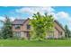 Attractive two-story house with a stone and siding facade, complemented by a lush green lawn and mature trees at 1421 Stoney Creek Cir, Carmel, IN 46032
