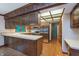Well-lit kitchen featuring wood cabinets, stainless steel refrigerator, and hardwood floors at 1421 Stoney Creek Cir, Carmel, IN 46032