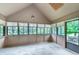Bright sunroom with multiple windows offering serene views of the surrounding greenery at 1421 Stoney Creek Cir, Carmel, IN 46032