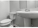 Clean half bathroom with pedestal sink and toilet, providing a functional and well-maintained space at 14584 Hinton Dr, Fishers, IN 46037