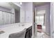 A well-lit bathroom with a vanity, a large mirror and a view to another bedroom at 14584 Hinton Dr, Fishers, IN 46037