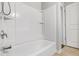 Bright bathroom features a white tub and shower with a tiled floor at 14584 Hinton Dr, Fishers, IN 46037