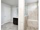 Modern bathroom featuring a tiled shower with a built-in bench and a vanity with dark cabinets at 14584 Hinton Dr, Fishers, IN 46037