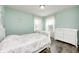 Brightly lit bedroom with hardwood floors, floral bedspread and an accent wall featuring a unicorn decal at 14584 Hinton Dr, Fishers, IN 46037
