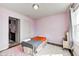 Cozy bedroom with pink walls, wood floors, with a twin bed, a rug, and plenty of natural light at 14584 Hinton Dr, Fishers, IN 46037