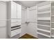 Organized walk-in closet featuring shelving units, drawers, and hanging rods for efficient storage at 14584 Hinton Dr, Fishers, IN 46037