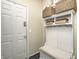 Charming entryway with a white hall tree and storage bench offers a welcoming spot to organize outerwear and accessories at 14584 Hinton Dr, Fishers, IN 46037