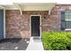 Inviting front entrance with a classic black door, brick facade, and manicured landscaping at 14584 Hinton Dr, Fishers, IN 46037