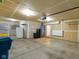 Unfinished garage featuring water filtration system, refrigerator, and door leading to the inside at 14584 Hinton Dr, Fishers, IN 46037