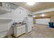 Unfinished garage with a refrigerator, storage cabinet, overhead hanging storage, and a trash can at 14584 Hinton Dr, Fishers, IN 46037