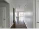 Bright hallway showcasing hardwood floors, neutral paint, and an open view of the living space at 14584 Hinton Dr, Fishers, IN 46037