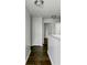Hallway with wood floors, white trim, and neutral paint at 14584 Hinton Dr, Fishers, IN 46037