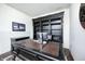 This home office features an impressive dark wood desk and shelving unit with a rolling ladder for upper shelf access at 14584 Hinton Dr, Fishers, IN 46037