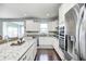 Bright kitchen features granite countertops, stainless appliances and hardwood floors at 14584 Hinton Dr, Fishers, IN 46037