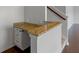 Stairway landing showcasing granite countertop desk nook with white cabinets and three drawers at 14584 Hinton Dr, Fishers, IN 46037