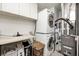 Convenient laundry room featuring a stacked washer and dryer and plenty of storage cabinets at 14584 Hinton Dr, Fishers, IN 46037