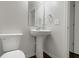 Stylish powder room with sleek pedestal sink, toilet, and updated fixtures providing a modern touch at 14584 Hinton Dr, Fishers, IN 46037