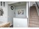 Staircase and entryway featuring neutral tones and artistic wall decor at 14584 Hinton Dr, Fishers, IN 46037