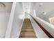Carpeted stairway featuring a wooden railing that leads to the upper level of the home at 14584 Hinton Dr, Fishers, IN 46037