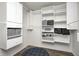 Spacious walk-in closet with custom shelving, drawers and a padded round bench for added convenience at 14584 Hinton Dr, Fishers, IN 46037
