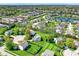 An aerial view shows a residential neighborhood with green lawns, mature trees, and a pond at 14817 Deerwood Dr, Carmel, IN 46033