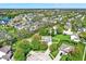 An aerial view captures a neighborhood with mature trees, well-manicured lawns, and a community pond at 14817 Deerwood Dr, Carmel, IN 46033