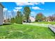 Large backyard with healthy green lawn and white picket fence surrounding the property at 14817 Deerwood Dr, Carmel, IN 46033