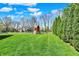 Large, grassy backyard featuring a wooden playset, perfect for Gathering fun at 14817 Deerwood Dr, Carmel, IN 46033