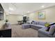Finished basement showcasing a sectional sofa, ping pong table, and stylish decor at 14817 Deerwood Dr, Carmel, IN 46033