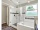 Bathroom with a glass shower, soaking tub, and a bright window at 14817 Deerwood Dr, Carmel, IN 46033