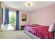 Cozy bedroom with pink walls, a comfortable bed, and a window with natural light at 14817 Deerwood Dr, Carmel, IN 46033