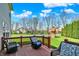 A wooden deck featuring outdoor furniture and a view of the green backyard and playground at 14817 Deerwood Dr, Carmel, IN 46033