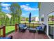 Cozy outdoor deck with comfortable seating, a table, and a blue umbrella, perfect for relaxing at 14817 Deerwood Dr, Carmel, IN 46033