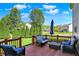 Relaxing deck area with comfortable seating and a view of the manicured lawn and landscaping at 14817 Deerwood Dr, Carmel, IN 46033