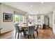 Bright open dining area features modern lighting, and flows into a modern kitchen space at 14817 Deerwood Dr, Carmel, IN 46033