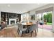 Open-concept dining area with access to deck features a fireplace, built-in shelving, and seamless indoor-outdoor living at 14817 Deerwood Dr, Carmel, IN 46033