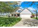 Inviting two-story home with manicured lawn, flowering trees, and an attached two-car garage at 14817 Deerwood Dr, Carmel, IN 46033