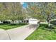 Charming home with mature flowering trees, well-manicured lawn, and long driveway at 14817 Deerwood Dr, Carmel, IN 46033