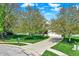 Charming home with a neatly maintained front yard and a concrete driveway framed by lush trees at 14817 Deerwood Dr, Carmel, IN 46033