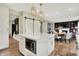 Open kitchen layout featuring white cabinetry, island with microwave, and seamless flow to dining and living areas at 14817 Deerwood Dr, Carmel, IN 46033