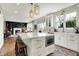 Sunlit kitchen featuring an island with seating, quartz countertops, stainless steel appliances, and open-concept design at 14817 Deerwood Dr, Carmel, IN 46033